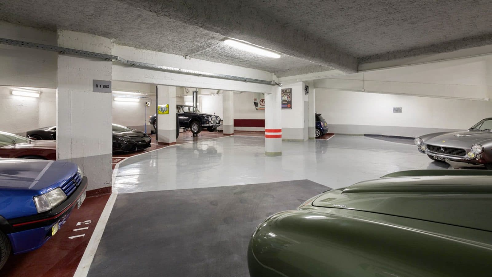 Garage aisle with cars under neon lights